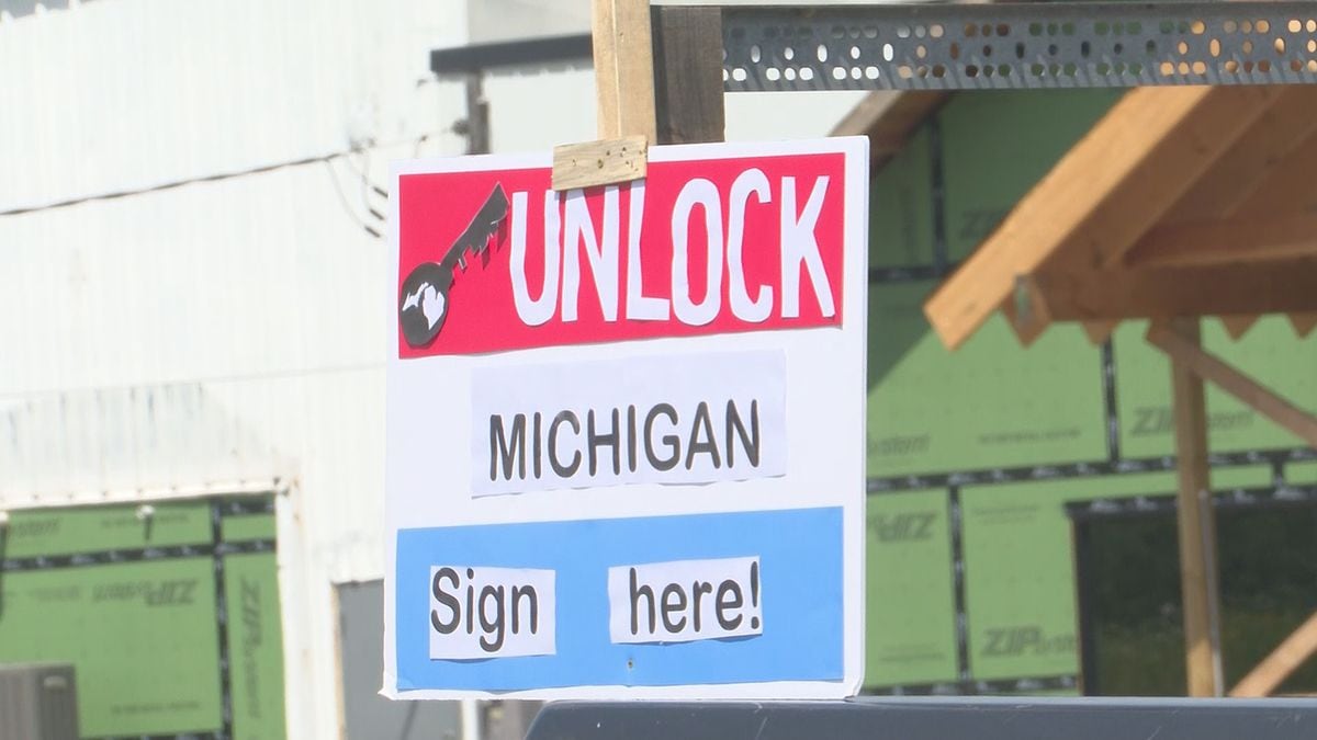 An "Unlock Michigan" sign is seen in Dickinson County, July 2020.