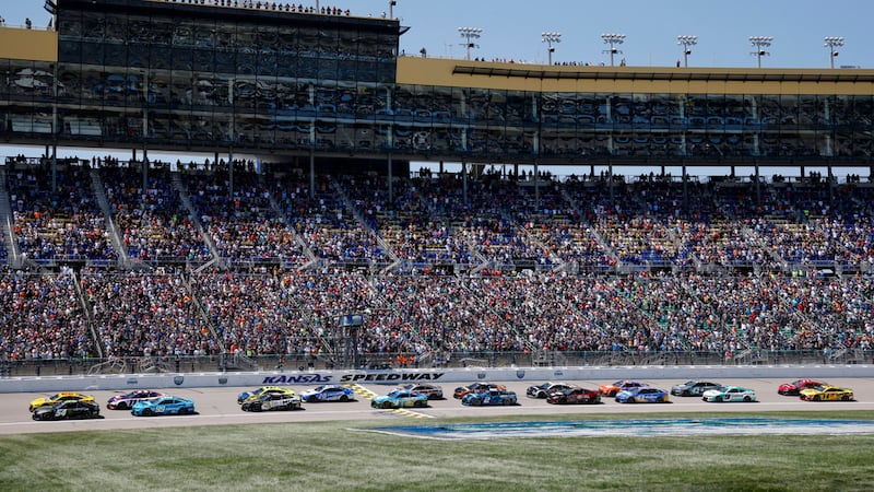 Drivers head down the front straightaway at the start of a NASCAR Cup Series auto race at...