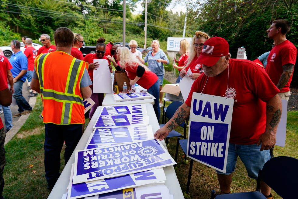 FILE - United Auto Workers members and supporters picket outside a General Motors facility in...