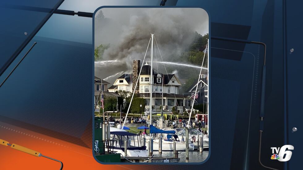 The Stingel family looks on as firefighting crews put out the fire at the Brigadoon Cottage on...