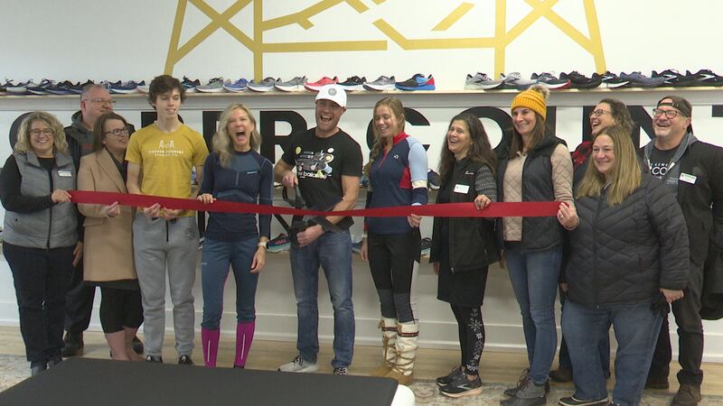 Kevin Thomsen, Copper Country Running Co.’s owner, cuts the ribbon at his new store