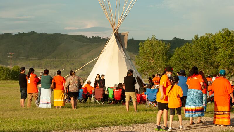 A vigil takes place where ground-penetrating radar recorded hits of what are believed to be...