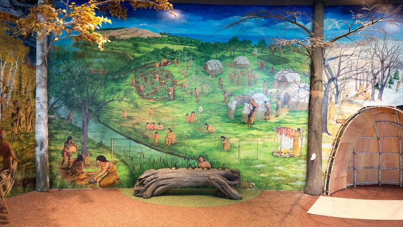 The new exhibit at the Michigan History Museum in Lansing includes a large mural that depicts...