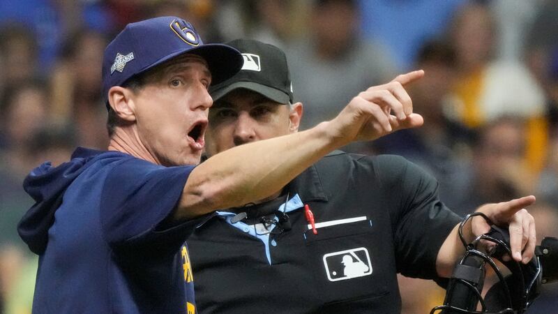 Milwaukee Brewers manager Craig Counsell argues withhome plate umpire Mark Ripperger during...