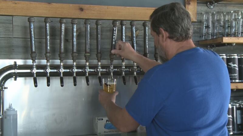 Jeff Brickey pours 'Yooper Strong' (WLUC Photo)