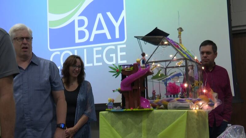 Bay College faculty and staff looking at everyone's greenhouse.