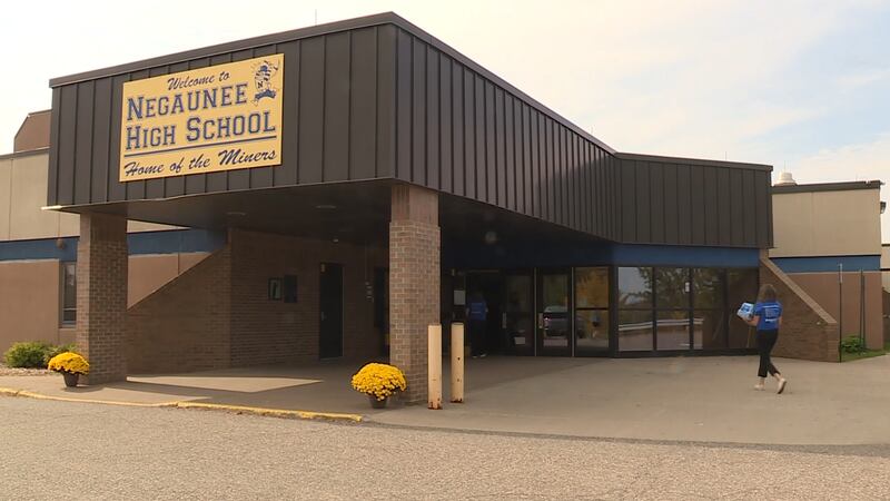 Range Bank employee dropping off school supplies at Negaunee High School
