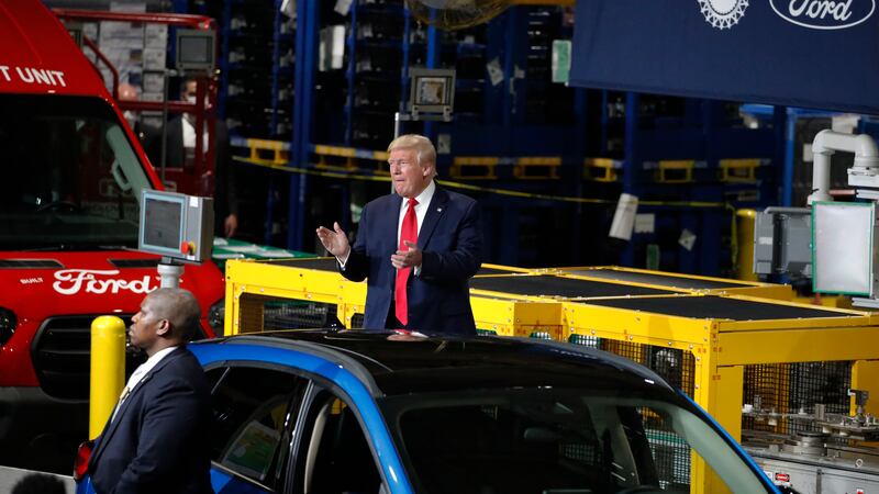FILE - President Donald Trump claps as he walks to the podium to speak at Ford's Rawsonville...