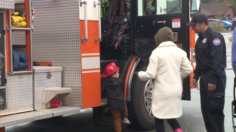 A child climbs into a Marquette Township Fire Department truck