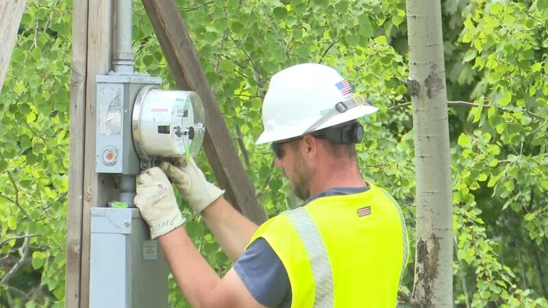 A construction worker adjusts a meter. (WLUC Photo)