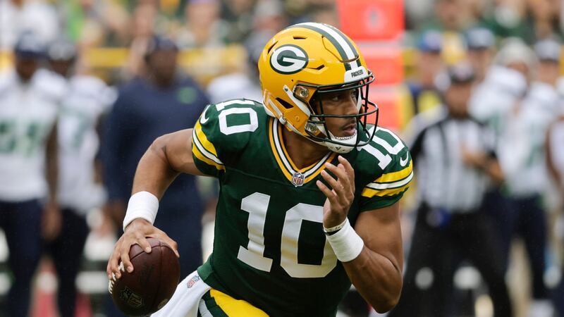 Green Bay Packers quarterback Jordan Love (10) scrambles up field in the first half of a...
